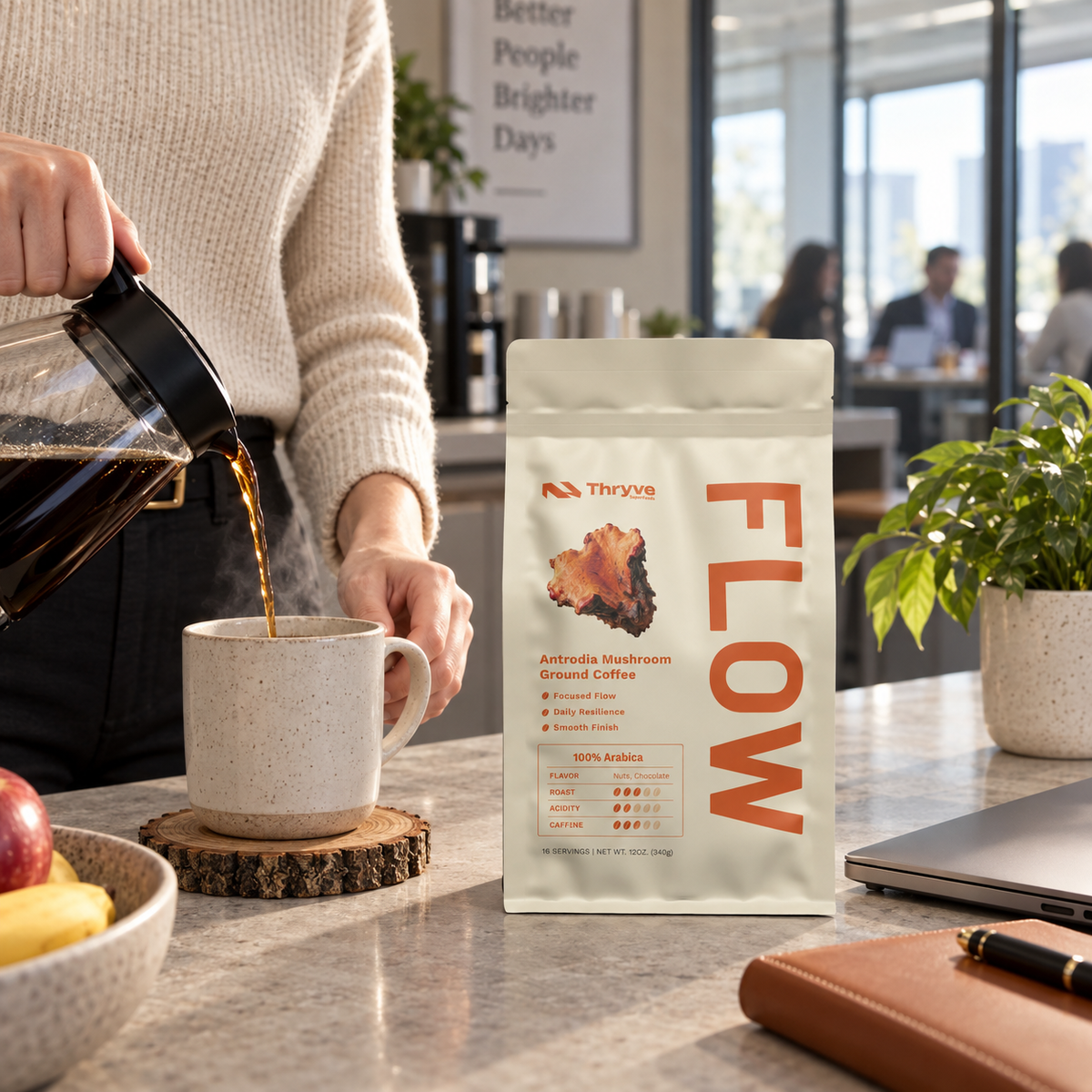 Pouring Thryve FLOW Antrodia Mushroom Ground Coffee during a morning office coffee routine